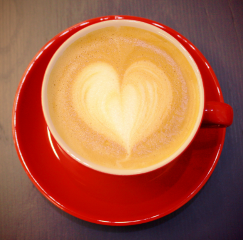 Coffee with heart in red dishware