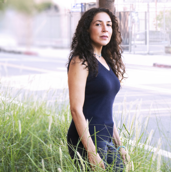 Toni Ann Johnson standing in the tall grass